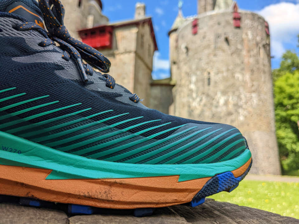 HOKA Torrent 2 trail running shoe with castle in the background