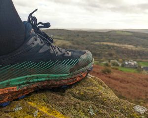 HOKA Torrent 2 trail running shoe with hills in the distance
